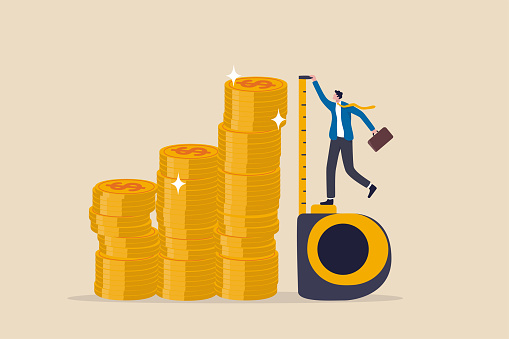 Investment measurement or benchmark, ROI, return on investment, wealth monitoring with financial goal or target concept, businessman investor using measuring tape to measure money coins stack height.