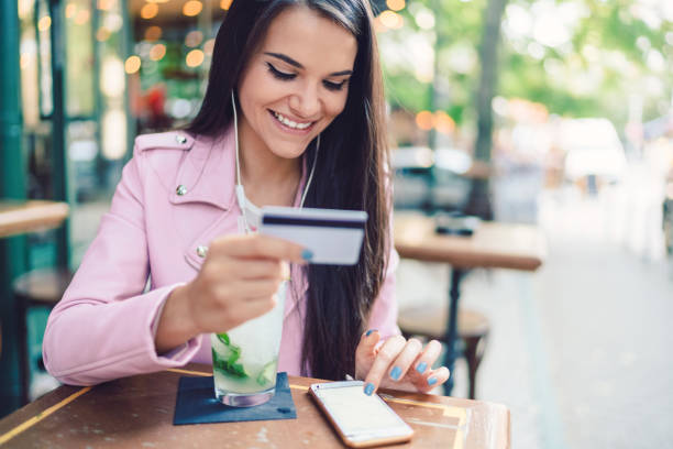 istock Woman in cafe online shopping 1326430202