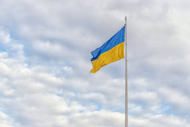 istock Cloudy sky with Ukrainian flag waving in the wind. 1326430422