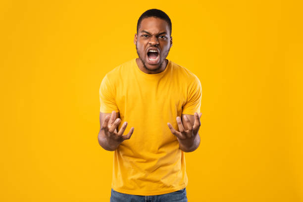 istock Angry African American Man Shouting Expressing Anger Over Yellow Background 1326430783