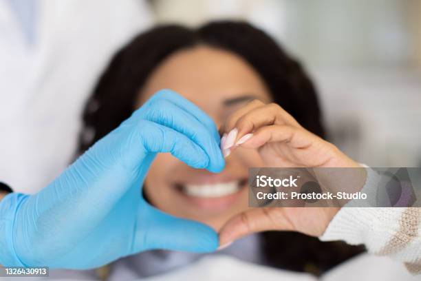 Closeup Of Dentist Doctor And Female Patient Making Heart Gesture With Hands Stock Photo - Download Image Now
