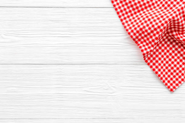 istock Red picnic cloth on wooden table, top view 1326432391