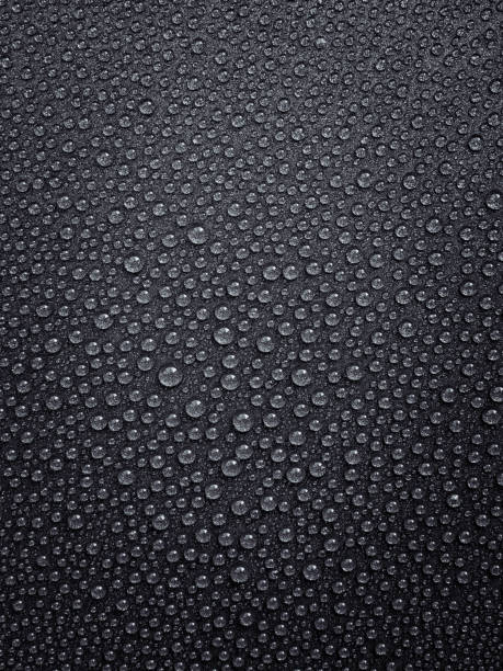 istock vertical background: water droplets with highlights on a dark surface 1326436413