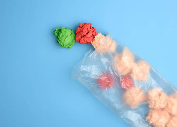 istock transparent plastic bag with crumpled sheets of paper on blue background 1326436509