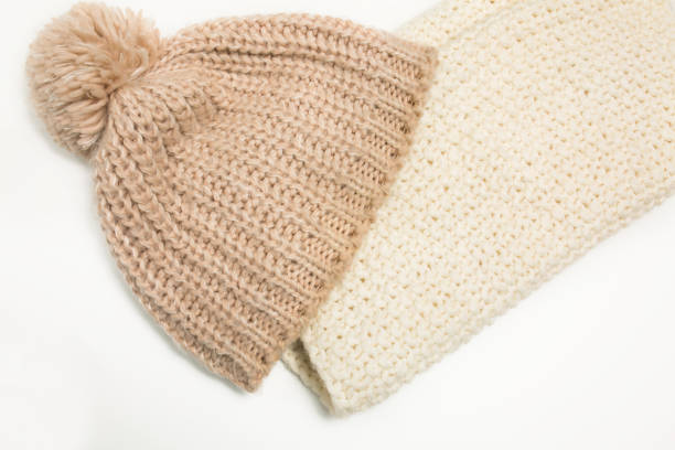 istock Large-knitted hat and white scarf snud on white background 1326437181