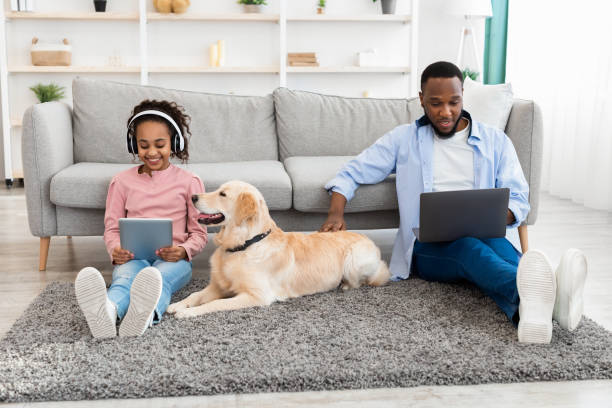 istock Black family spending time together at home with dog 1326437399
