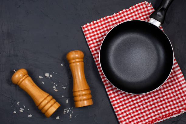 istock Empty black frying pan or skillet with pepper and sea salt 1326438778