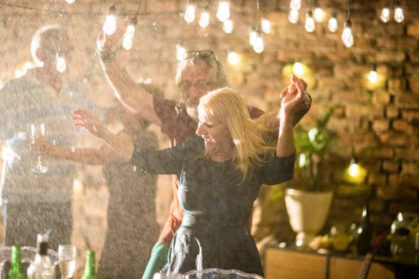 istock Group of senior people dancing on garden party while it's raining 1326438931