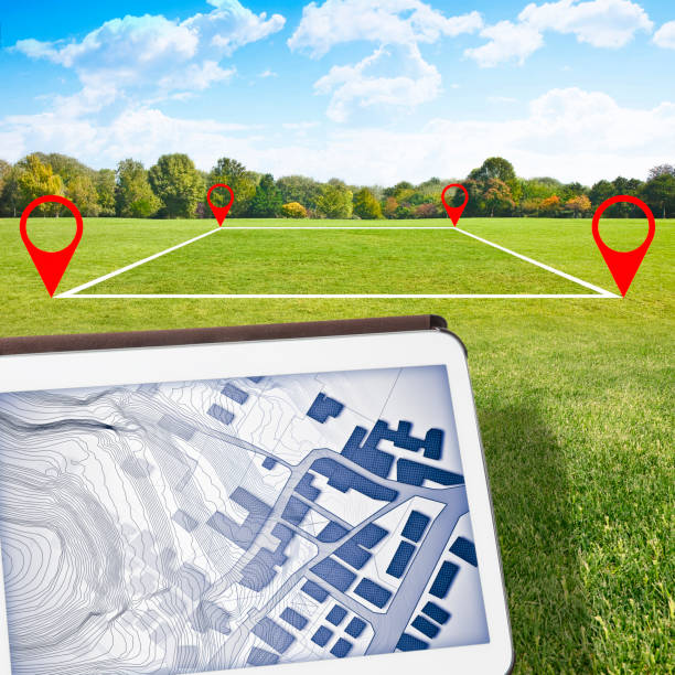 istock Land plot management - real estate concept with a vacant land on a green field available for building construction and housing subdivision in a residential area for sale - Digital tablet on foreground with an imaginary cadastral map 1326439441