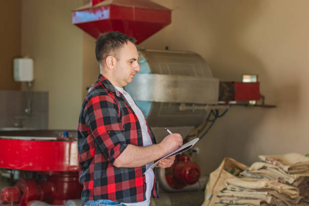 istock Man working in coffee roasting factory 1326443187