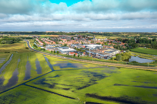 Aerial footage of as typical suburban housing estates and wetlands in the foreground.