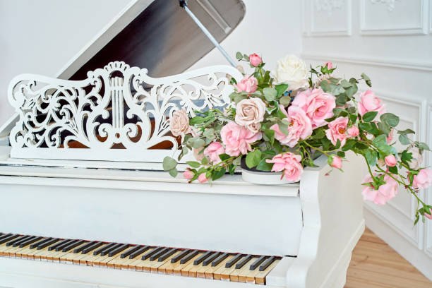istock White grand piano with rose flowers, copy space 1326443599