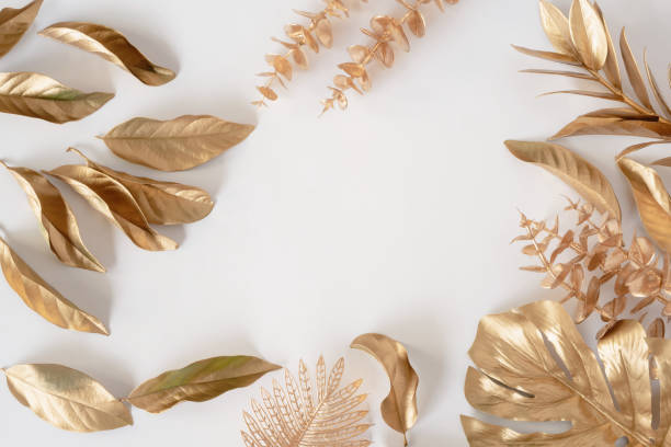 istock Gold tropical palm leaves Monstera on white background. Flat lay 1326444677