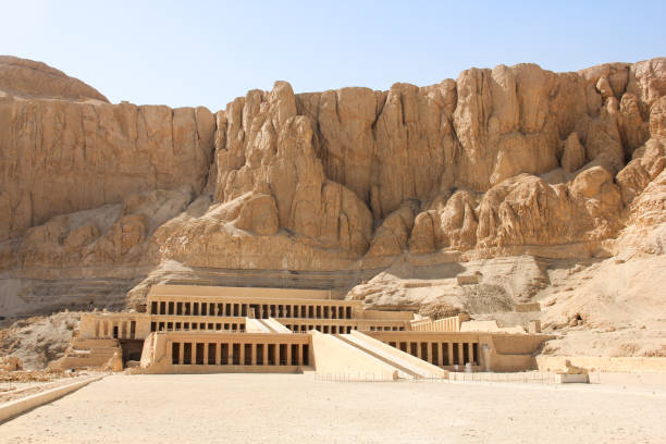 View of the Mortuary Temple of Queen Hatshepsut, located under the rocks in Deir el-Bahari, Valley of the Kings. Monument of ancient Egyptian architecture in Luxor View of the Mortuary Temple of Queen Hatshepsut, located under the rocks in Deir el-Bahari, Valley of the Kings. Monument of ancient Egyptian architecture in Luxor luxor thebes photos stock pictures, royalty-free photos & images