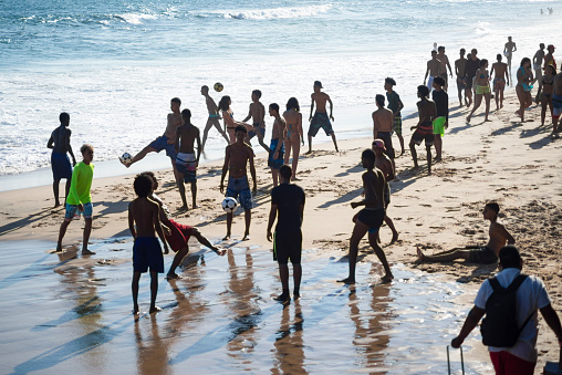 Salvador, Bahia, Brazil - October 16, 2021: Young people ignore the coronavirus contamination and flock to Farol da Barra beach. The beaches were cleared for bathers a few days ago.