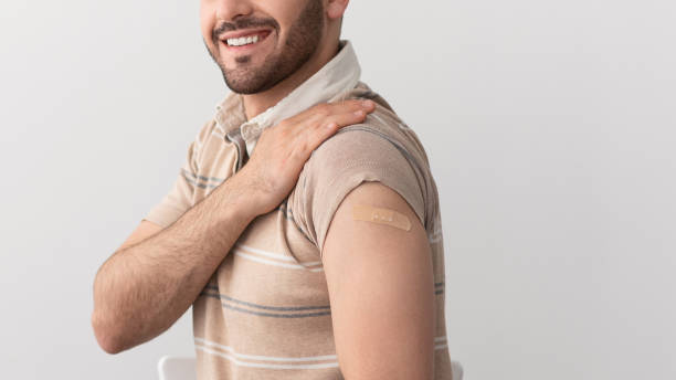 istock Guy Showing Vaccinated Arm After Antiviral Injection, Studio Wall 1326446086