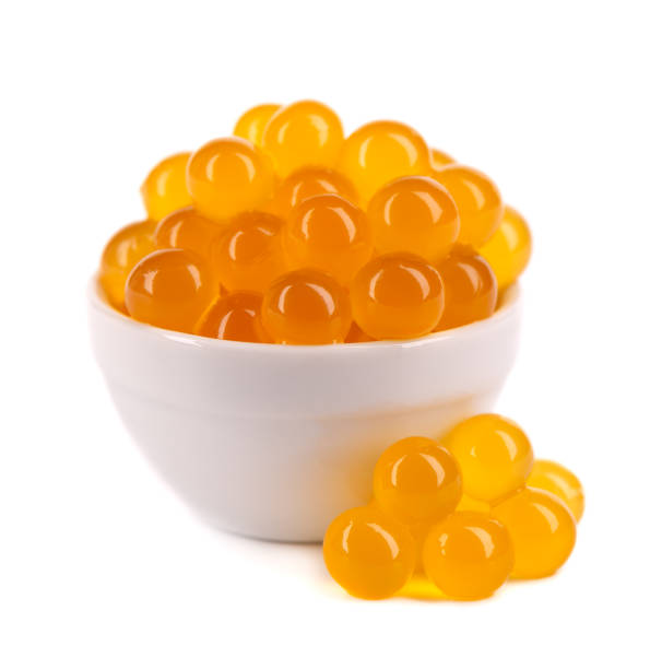 istock Red tapioca pearls for bubble tea isolated on white background. Tapioca pearls in white ceramic spoon. 1326446270
