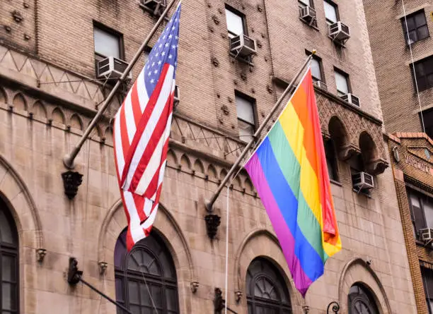 New York City rainbow and American flag next to each other on a building support pride month