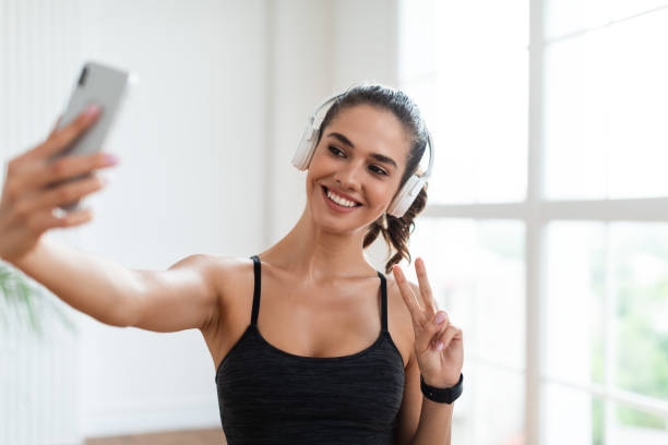 istock Fitness lady making selfie photo on smartphone during workout break 1326449962