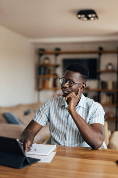 istock Adult African man, coming up with new ideas, while working. 1326450974