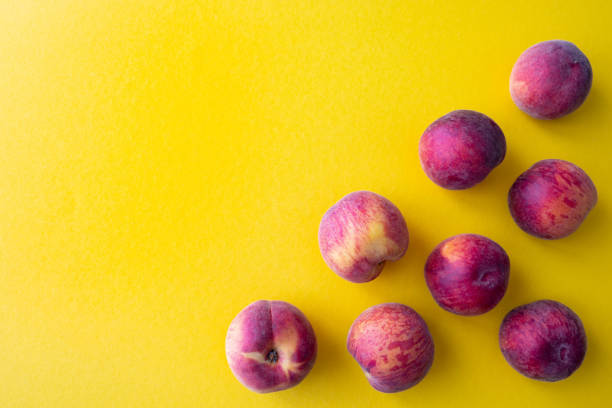 ripe peaches on a yellow background, on the right side
