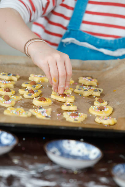 istock Child bakes and decorates cookies. 1326451249