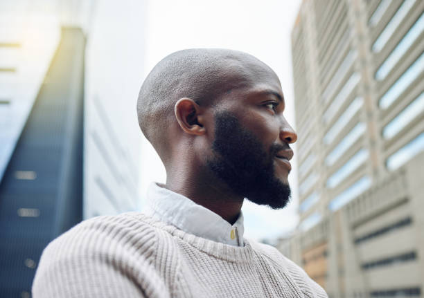 istock Low angle shot of a handsome young businessman looking thoughtful while standing on the balcony of his office 1326451794