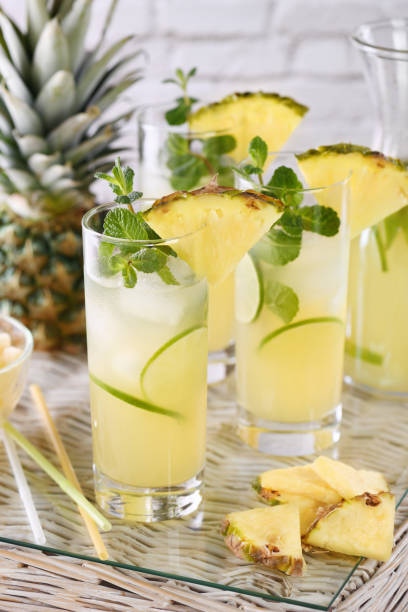 Fresh lime and mint combined with fresh pineapple juice and tequila. Pineapple cocktails always have a bright taste and aroma! stock photo