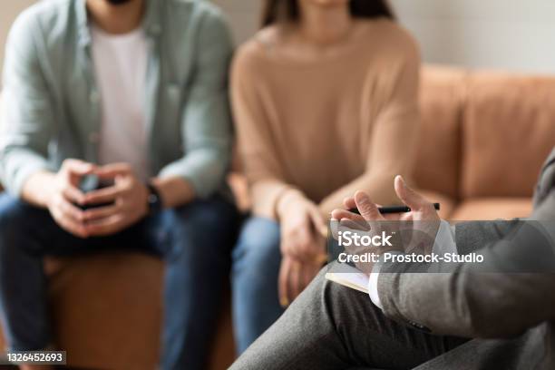 Couple Talking At Session With Male Therapist Stock Photo - Download Image Now - Psychotherapy, Couple - Relationship, Mental Health Professional
