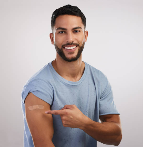 Shot of a handsome young man sitting alone in the studio after getting vaccinated
