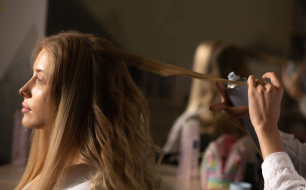 istock Hair stylist making hair styling 1326454120