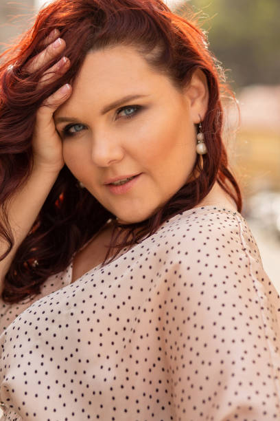 istock Pretty red haired middle-aged woman looking at the camera with a charming smile 1326455743