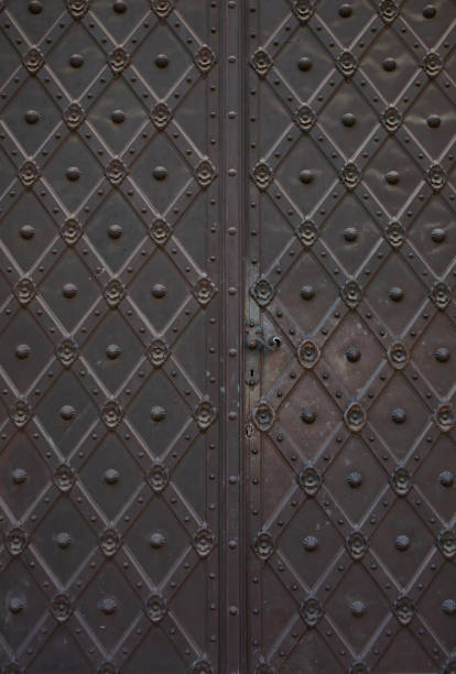 istock Old forged door with a knob and keyhole 1326455780