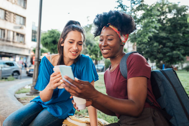 istock Two female students enjoying coffee and a chit chat in the park 1326455844