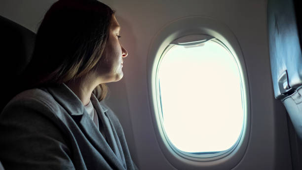 istock Young woman looking through the porthole 1326456592
