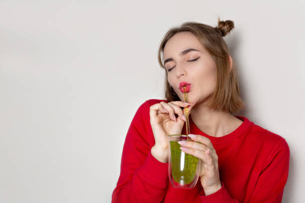 istock Delightful woman drinking green juice with chia seed 1326457137