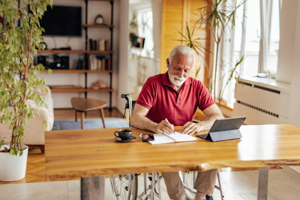 istock Disabled senior man, brainstorming about his new book. 1326458021