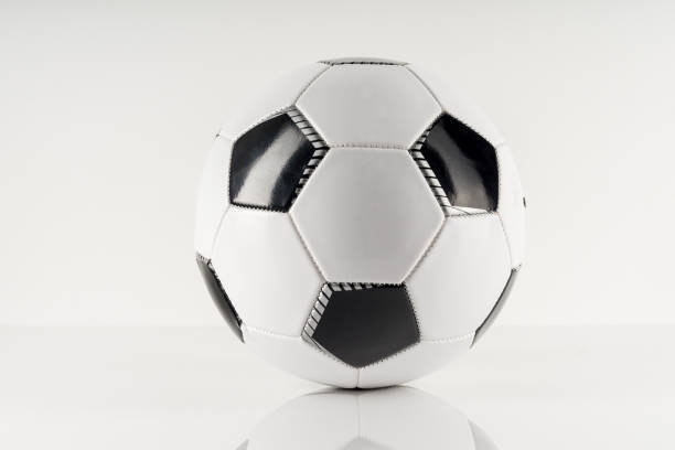 istock Classic soccer ball, typical black and white pattern, isolated on white background. 1326459218