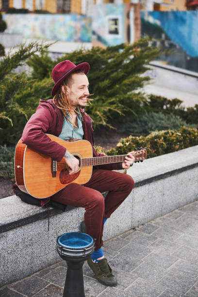 istock Kind informal guy entertaining people with instrumental music 1326459752