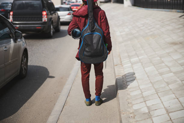 istock Young street musician keeping guitar case on his back 1326460537