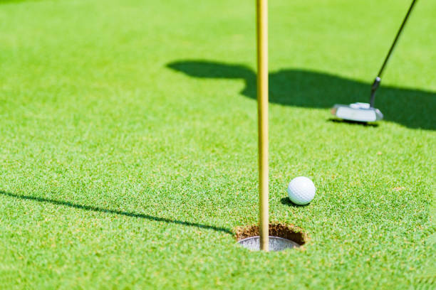 istock putter and golf ball on the green 1326463821