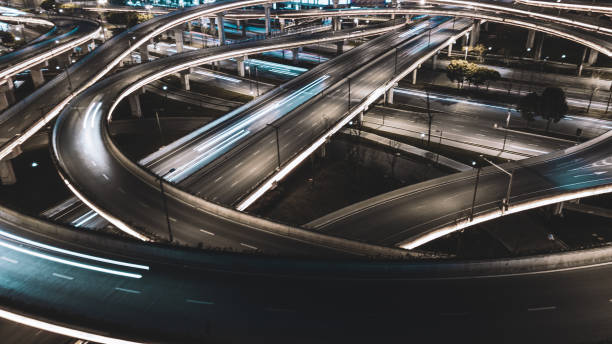 istock Night long exposure illumination of elevated multilevel traffic junction. Modern development of backlighted roads and current new infrastructure in China, Chengdu. Aerial drone point of view. 1326464259