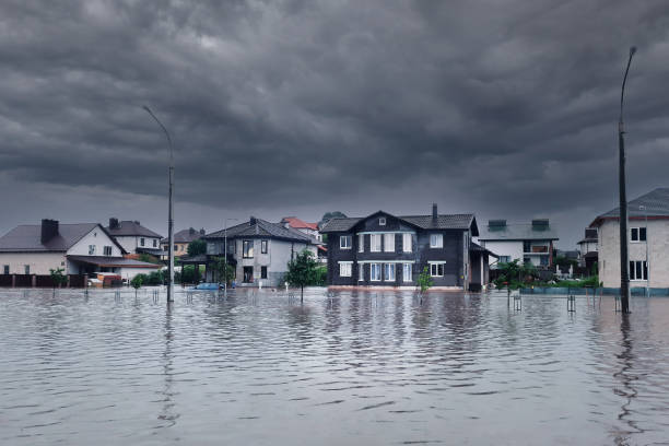 Extreme heavy rain storm weather. Flooded streets of the neighborhood. A flooded road junction with a drowned house. Heavy rains from tropical storm caused many flooded areas. Rains caused many floods Bad extreme heavy rain storm weather. Flooded streets of the neighborhood. A flooded road junction with a drowned car. Heavy rains from tropical storm caused many flooded areas. russia city spring stock pictures, royalty-free photos & images