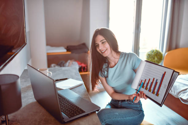 istock Smiling Female Business Student Explaining Graphic Chart Calculations During Video Conference 1326466334