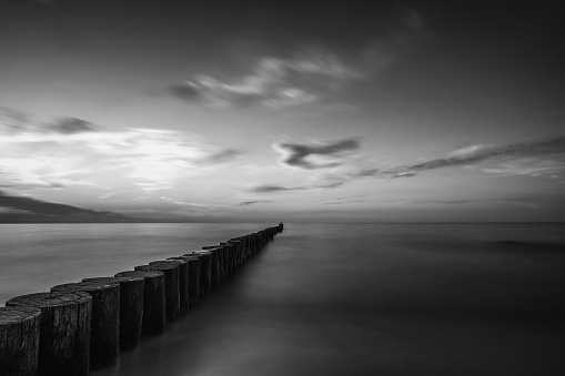 melancholy landscape of a sea at sunset in black and white