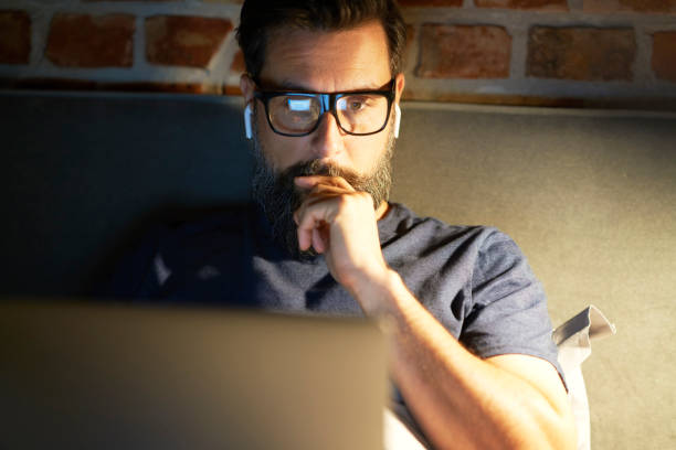 istock Close up front view of man working late in bed 1326469082