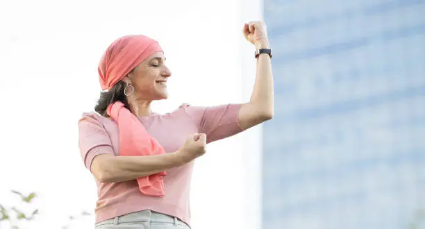 woman with pink headscarf fighting cancer