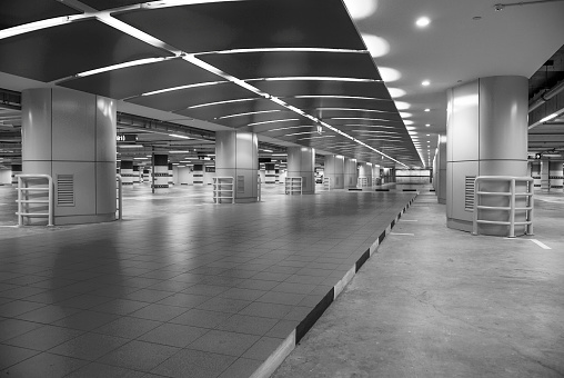 Black and white image of a parking garage.