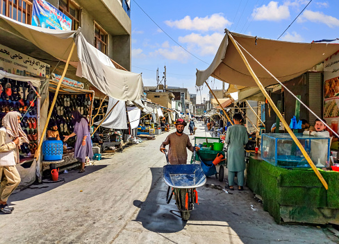 Mazar-i-Sharif - Afghanistan - June 28, 2021: Afghan peoples are shopping and walking Old city bazaar of Kabul, AfghanistanIt is a city on the border of Uzbekistan.