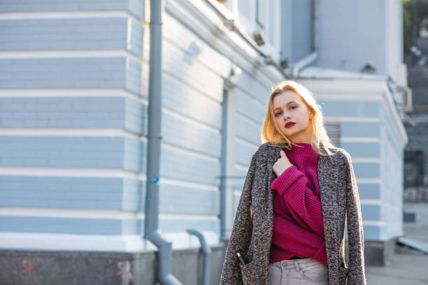 istock Wonderful blonde woman wearing coat and scarf, posing with soft backlight. Empty space 1326474171